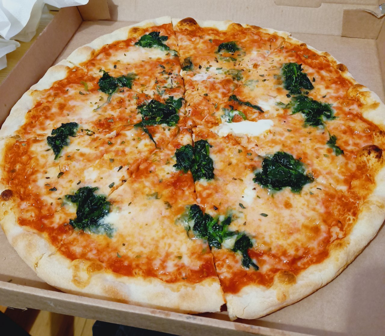 Spinach Taleggio pizza from Simon Boccanegra in a delivery box